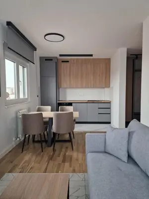 a living room with a couch and a table at Lux apartman 2 Ledine in Ledine