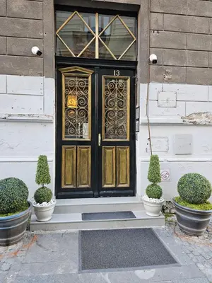 a door on a house with potted plants in front at Belgrade Luxury Suite 17 in Belgrade