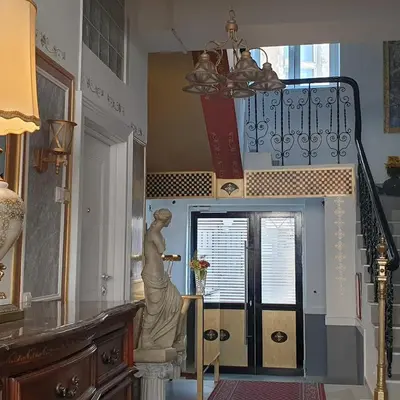a staircase with a statue of a woman on a stand in a room at Belgrade Luxury Suite 17 in Belgrade