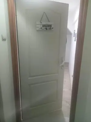 a white door with a sign on it in a hallway at Small low cost studio Dorcol in Belgrade