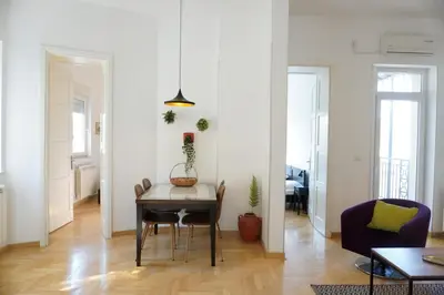 a living room with a table and a couch at 155sqm 4BR Central Belgrade Apartment for 9 Guests in Belgrade