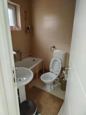 a small bathroom with a toilet and a sink at Apartman PRAMAC in Belgrade