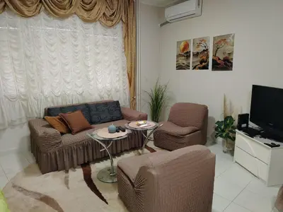 a living room with a couch and chairs and a tv at Apartman PRAMAC in Belgrade