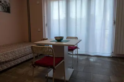 a room with a table and two chairs and a bed at Studio Anrora 3 in Belgrade