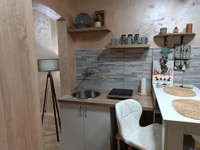 a kitchen with a sink and a counter with a lamp at Rustic central in Belgrade