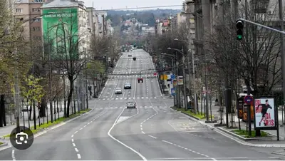 an empty road in a city with cars on it at Apartman Knez Miloš in Belgrade