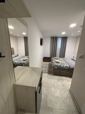 a bedroom with two beds and a large mirror at Apartman Knez in Belgrade