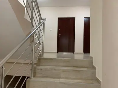 a hallway with two doors and stairs in a building at Mimura stan in Belgrade