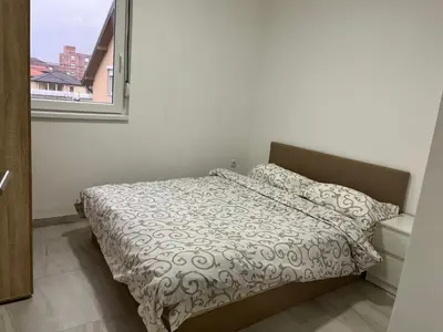 a bed in a small room with a window at Airport Art Villa in Čukarica