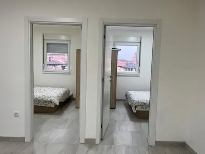 a room with two beds and two windows at Airport Art Villa in Čukarica