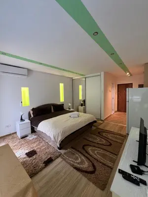 a bedroom with a large bed and a desk at Fontana in Belgrade