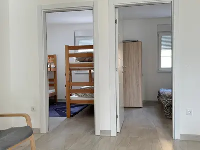 a room with a door open to a bedroom at Belgrade Airport Luxury Single in Surčin