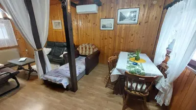 a room with a table and a chair and a room with a table at Wooden house Ada in Ada Ciganlija