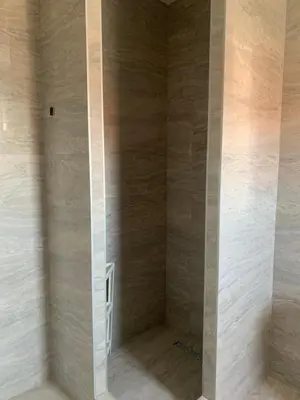 a bathroom with a shower with marble walls at Deluxe Belgrade Airport Single Room in Surčin