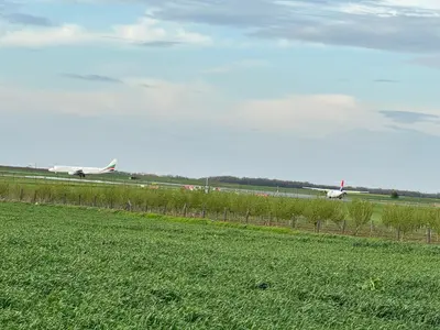 an airport runway with an airplane on the runway at Deluxe Double Room Belgrade Airport in Surčin