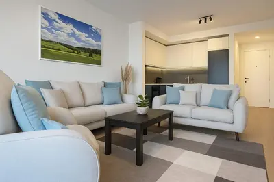 a living room with two couches and a table at Queen's Park Residence Apartments in Belgrade