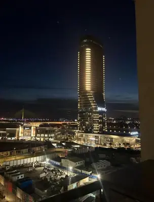 a tall building with lights on it at night at BW Simfonia Apartman 407-whit free garage parking in Belgrade
