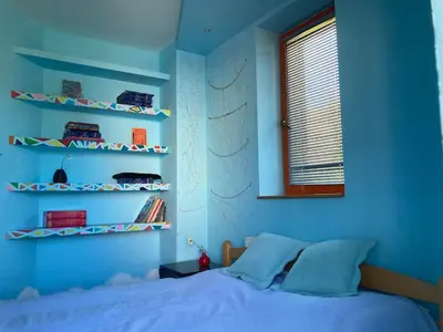 a bedroom with blue walls and a bed and shelves at Artists Inn, large 2 bed duplex apartment, parking in Železnička Stanica Zemunsko Polje