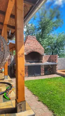 a brick pizza oven in a yard with a patio at Kucica na Dunavu in Kovin