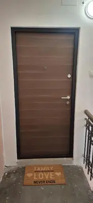 a garage door with a sign that reads never enter at Vanja's Apartman in Belgrade