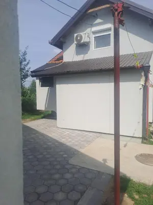 a house with a white garage with at Apartmani Petrušić