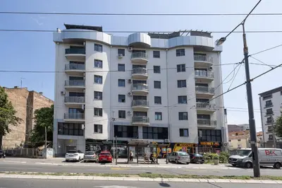 a white building with cars parked in front of it at Spa King Apartments 3 in Belgrade