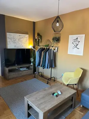 a living room with a tv and a coffee table at Mikos apartmani in Belgrade