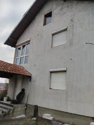 a man sitting on the steps of a house at Summer house in Belgrade in Slanci