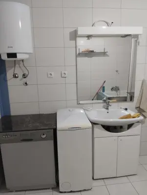 a white kitchen with a sink and a sink at Summer house in Belgrade in Slanci