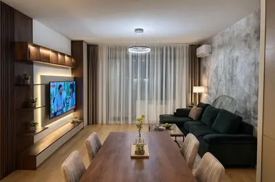 a living room with a table and a green couch at BW Loft Apartments FREE GARAGE Fast Wi-Fi in Belgrade