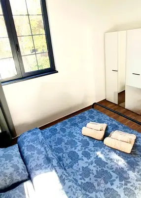 a bedroom with a bed with towels on it at Amar 2 in Belgrade