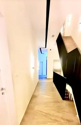 a hallway with a black staircase in a white room at Amar2 in Belgrade