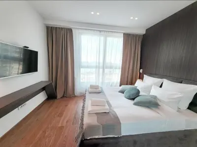 a bedroom with a large bed with a large window at Eterna Premium Apartment 1 Bedroom in Sajmište