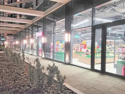 an empty grocery store aisle with glass doors at Eterna Premium Apartment 1 Bedroom in Sajmište