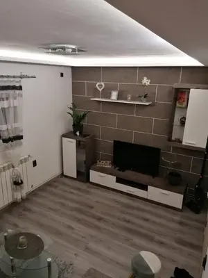 a living room with a flat screen tv on a wall at DEP House in Beograd
