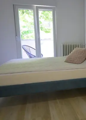 a large bed in a room with a window at Ellie Star Apartment in Belgrade