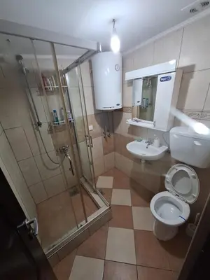 a bathroom with a shower and a toilet and a sink at Rooms1 in Beograd