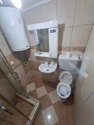 a small bathroom with a toilet and a sink at Rooms1 in Beograd