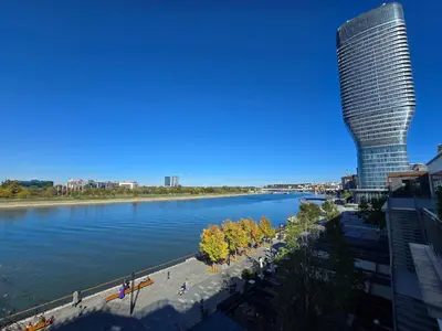 a view of a river with a tall building at BW Quartet 302 deluxe apartments in Belgrade