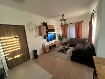 a living room with a couch and a television at Apartman 601 in Surčin
