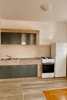 a kitchen with a white stove and a refrigerator at Apartman Kalina in Belgrade