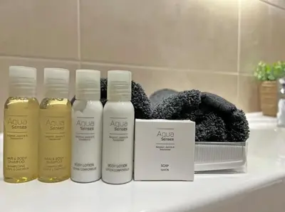 a group of three bottles of hair products on a bathroom counter at Metropoliten - Aria Lux Apartments BW in Belgrade