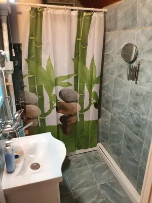 a bathroom with a shower curtain and a sink at Pure nature lovely view house in Zaklopača