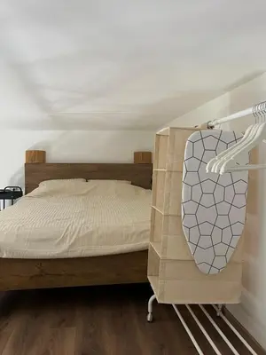 a bedroom with a bed with a wooden frame at City Loft in Belgrade