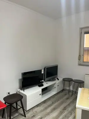 a living room with a tv on a white cabinet at Apartman Jovanović in Belgrade