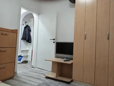 a room with a television on a table with a closet at Apartman Jovanović in Belgrade