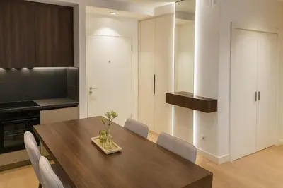 a kitchen with a wooden table and chairs at Belgrade Waterfront Premium LuX Apartment in Sajmište