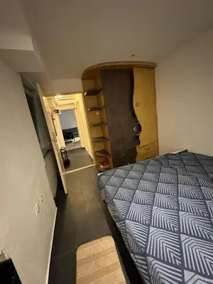 a small bedroom with a bed and a door at BelgradeCenterVibe in Belgrade