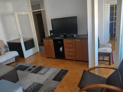 a living room with a flat screen tv on a dresser at Apartman86 in Beograd