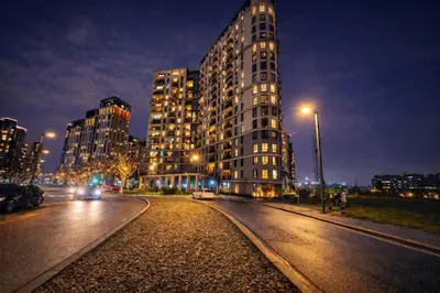 a tall building on a city street at night at Metropoliten Apartments Belgrade Waterfront in Belgrade